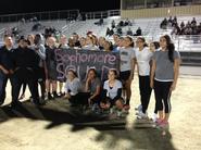 Students holding up a sign that says "Sophomores" on a grass field